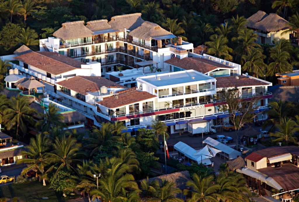 an aerial view of a resort with palm trees at Hotel Rockaway in Puerto Escondido