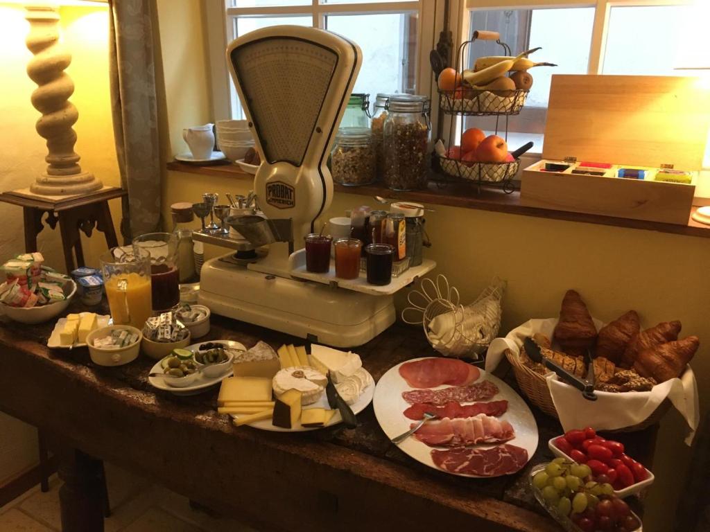 a table topped with lots of different types of food at Hotel de Charme 'zum Schiff' in Iffezheim