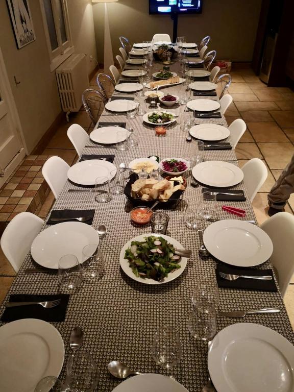 a long table with plates of food on it at The Castle, 10 Bedroom Chalet, Chamonix Centre in Chamonix