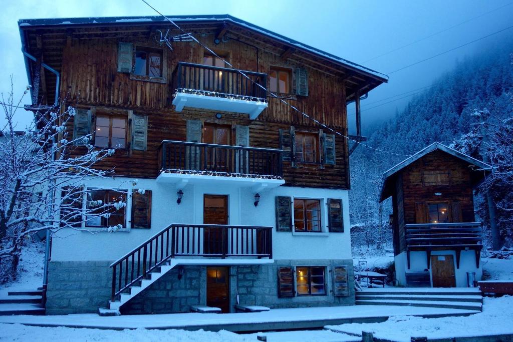 a large wooden house in the snow with stairs at The Castle, 10 Bedroom Chalet, Chamonix Centre in Chamonix