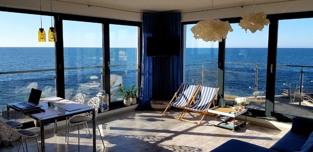 a living room with a view of the ocean at Apartament Morski przy Latarni in Darlowko