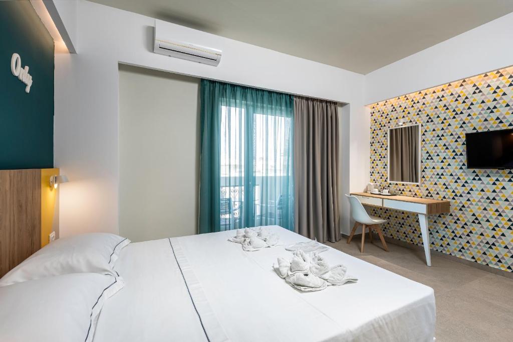 Postel nebo postele na pokoji v ubytování Olympia Hotel