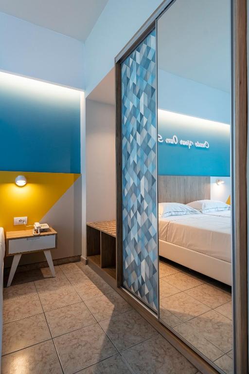 Postel nebo postele na pokoji v ubytování Olympia Hotel