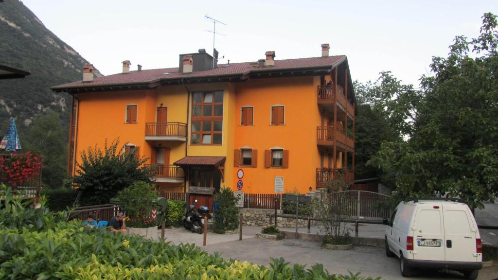 an orange building with a van parked in front of it at Residenza Arcobaleno in Tenno