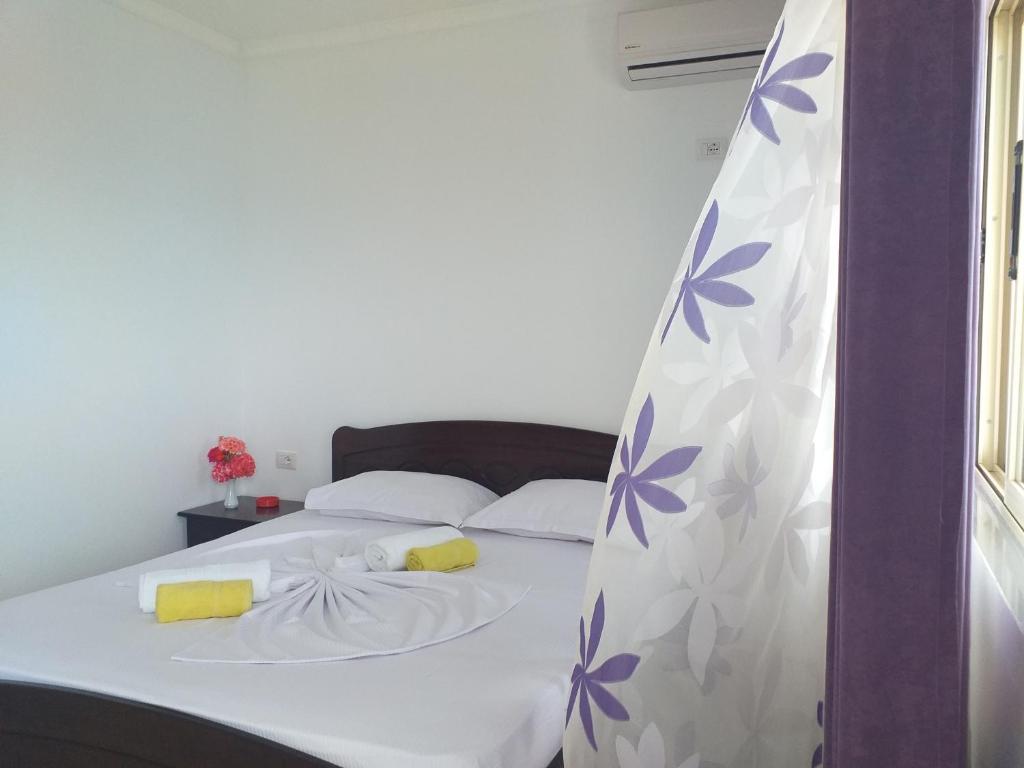 a bedroom with a bed with a curtain on it at Grand Seaview Apartments in Ksamil