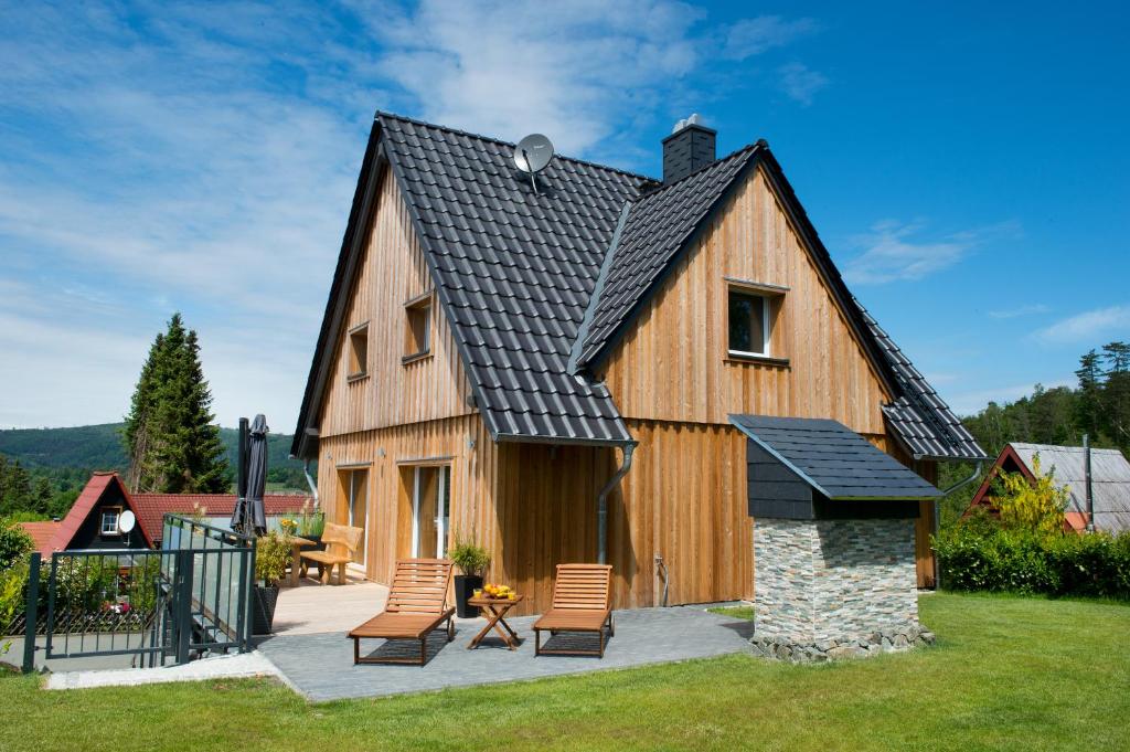 a large wooden house with a black roof at Haus Wulveshagen in Langelsheim