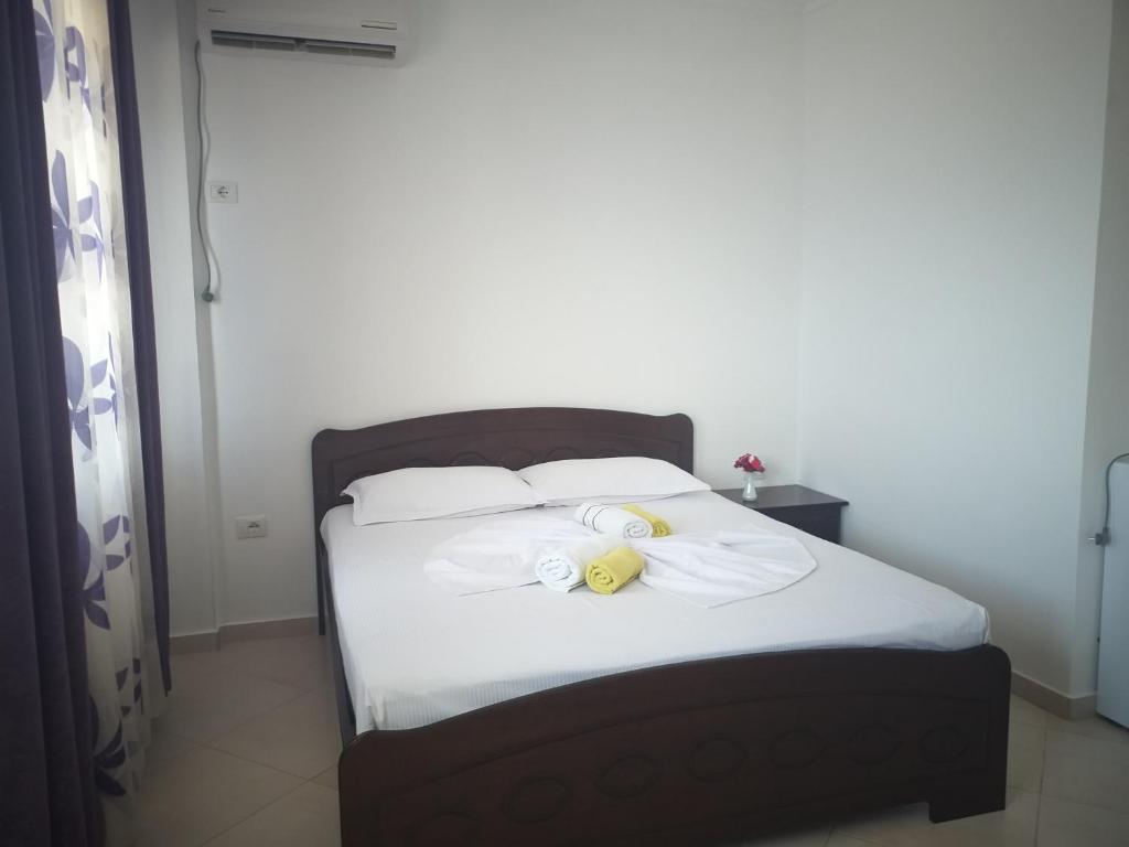 a bedroom with a bed with a stuffed animal on it at Grand Seaview Apartments in Ksamil