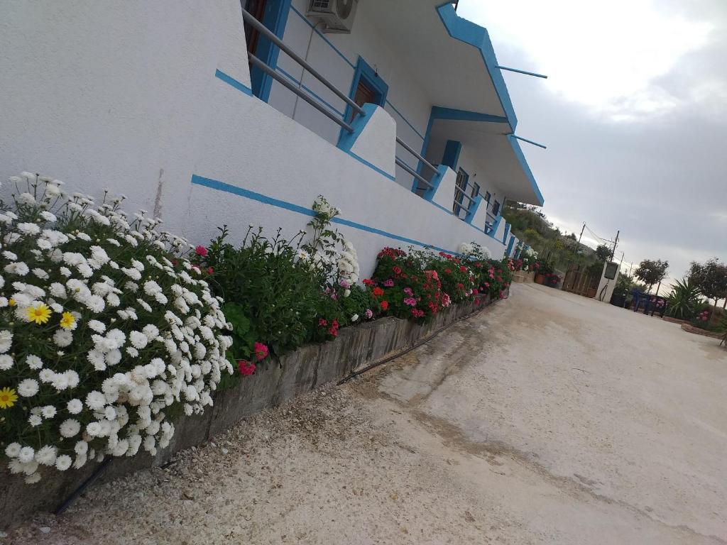 a building with flowers in front of a building at Grand Seaview Apartments in Ksamil
