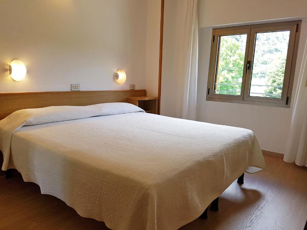 Łóżko lub łóżka w pokoju w obiekcie Albergo Miralaghi
