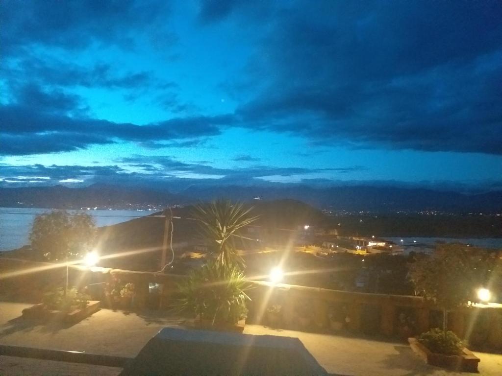 a view of a city at night with lights at Grand Seaview Apartments in Ksamil