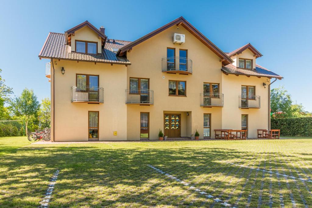 a large house with a yard in front of it at Danusia in Dębki