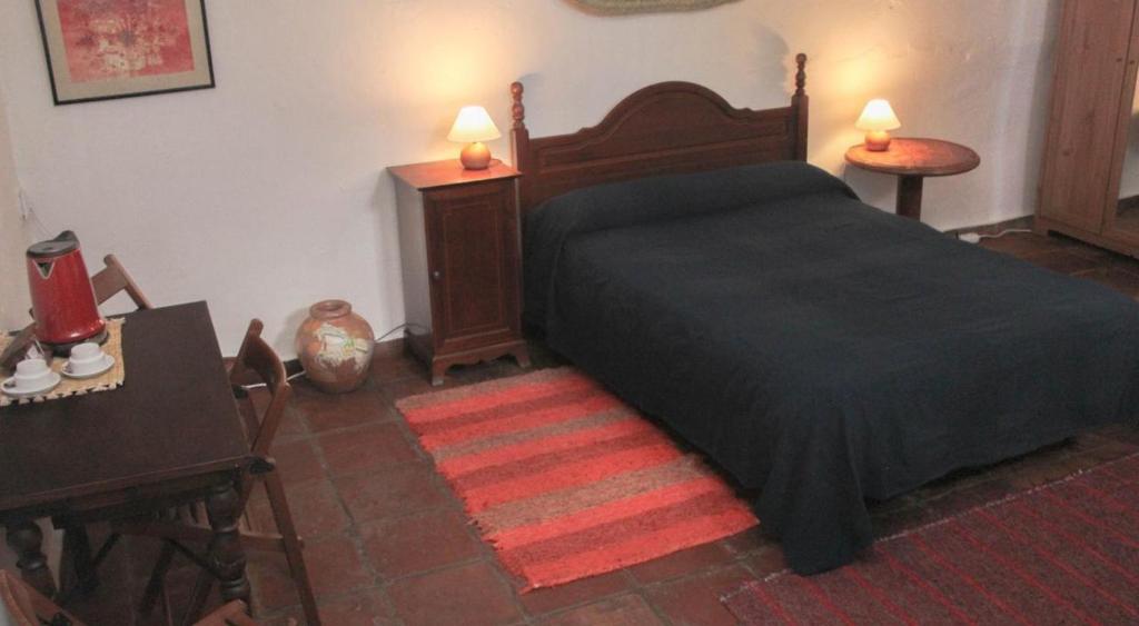 A bed or beds in a room at Casa Rural Catifalarga Alpujarra