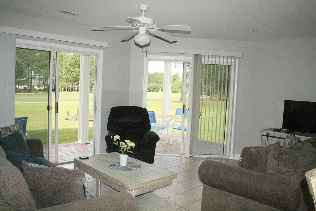 a living room with couches and a ceiling fan at 2503M condo in Calabash