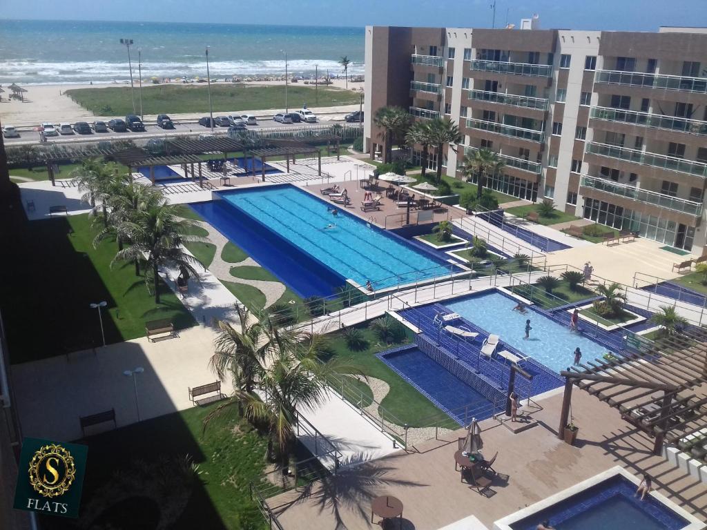 an overhead view of a swimming pool at a resort at vgfun S flats in Fortaleza