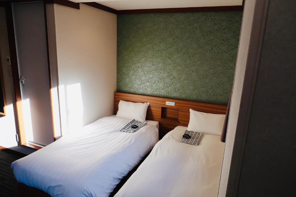 Postel nebo postele na pokoji v ubytování Ueno Touganeya Hotel
