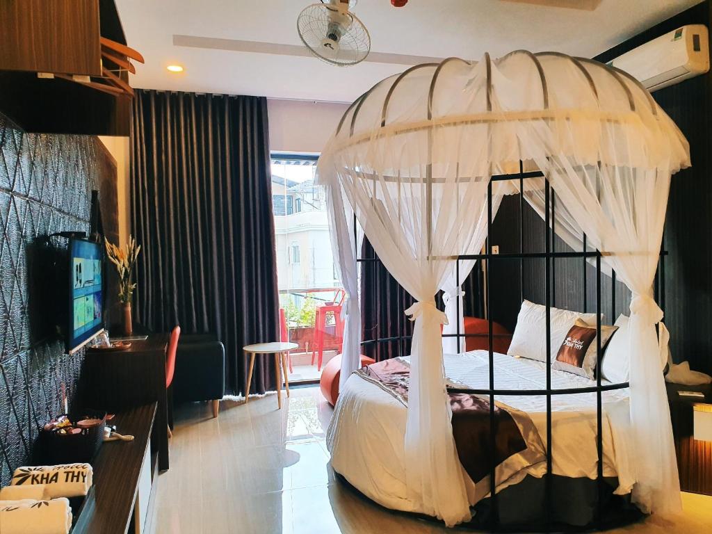 a bedroom with a bed with a canopy at Kha Thy Hotel 2 in Ho Chi Minh City