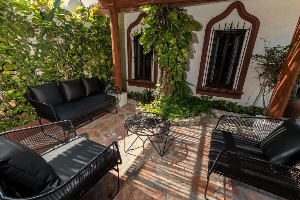a patio with couches and a table and chairs at Villas Carrizalillo in Puerto Escondido