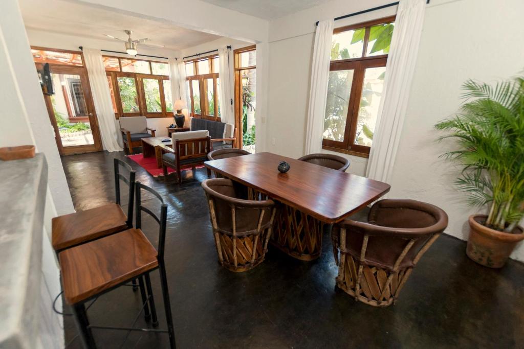 a dining room with a wooden table and chairs at Villas Carrizalillo in Puerto Escondido