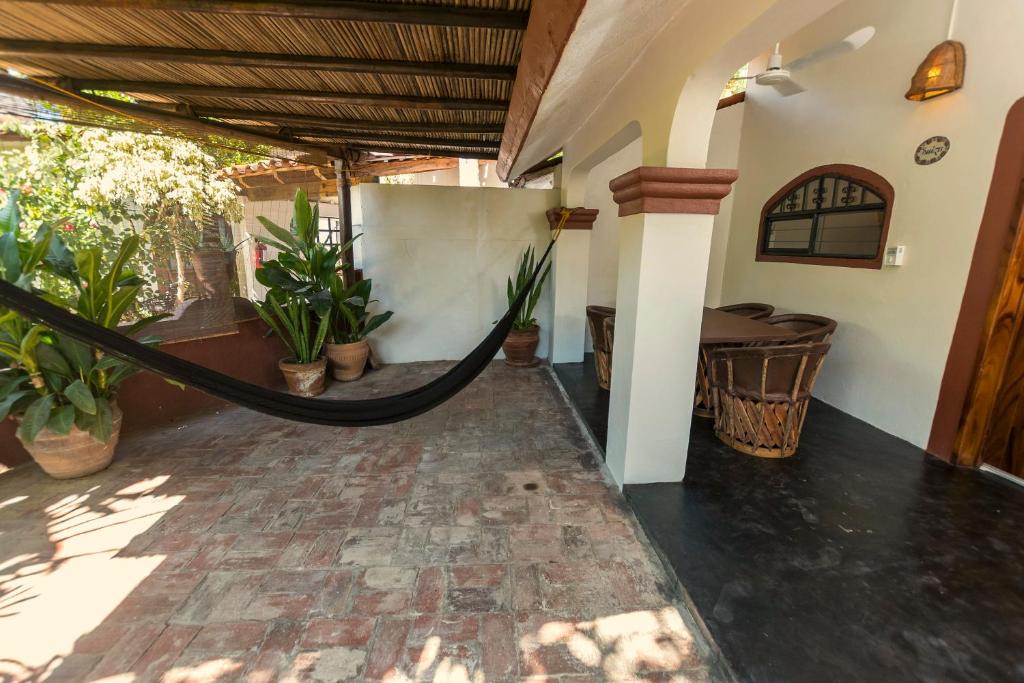 a hammock in the middle of a room with plants at Villas Carrizalillo in Puerto Escondido