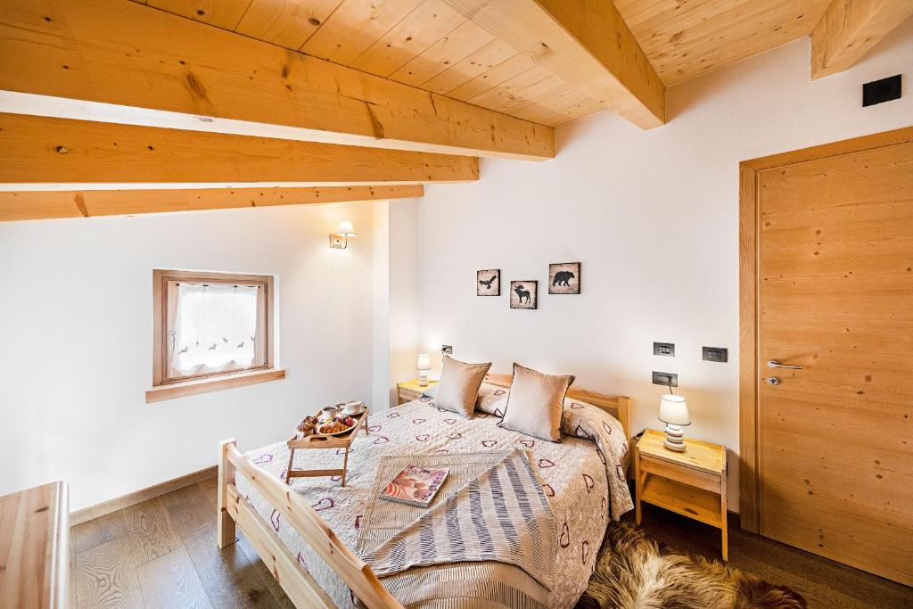 A bed or beds in a room at Chalet Resort Sozzine
