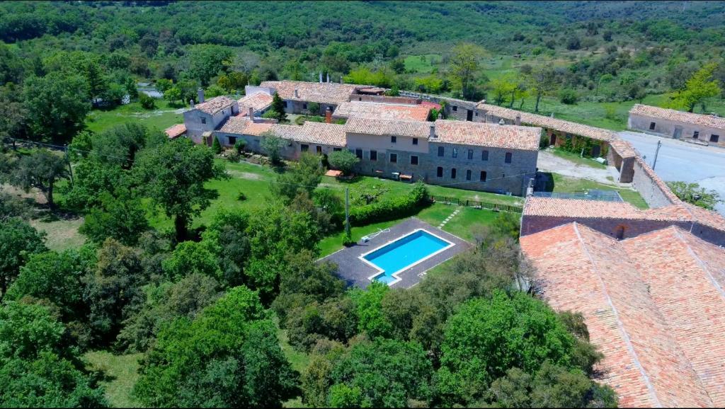 an aerial view of a house with a swimming pool at Fattoria Mongerrate in Isnello