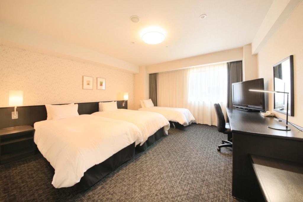 מיטה או מיטות בחדר ב-Richmond Hotel Nagoya Nayabashi