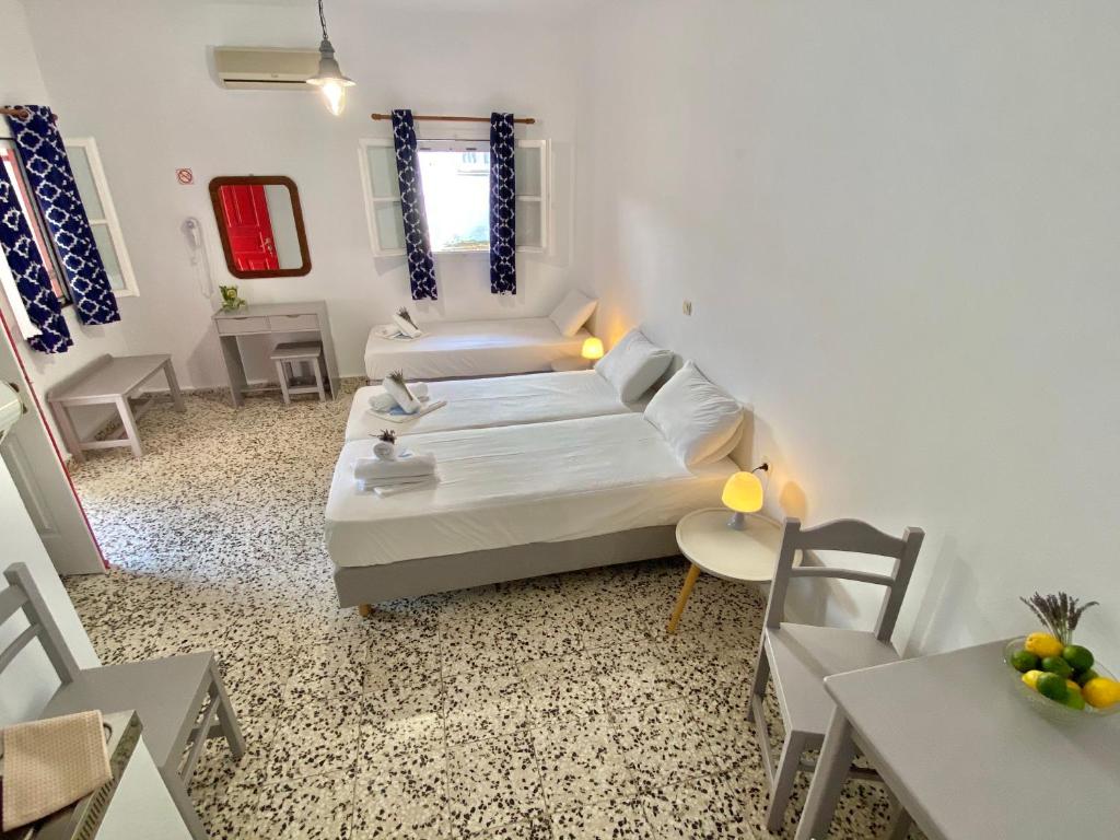 a small living room with a bed and a table at Anna Studios in Katapola