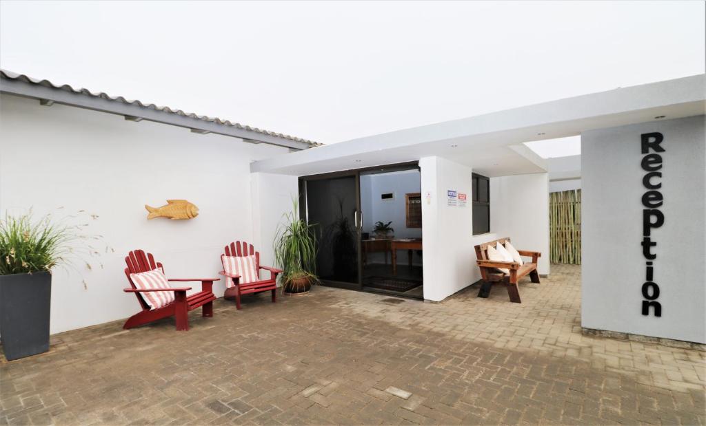 a patio with chairs and a table in a building at Tiende Laan Bed & Breakfast and Self-Catering in Walvis Bay
