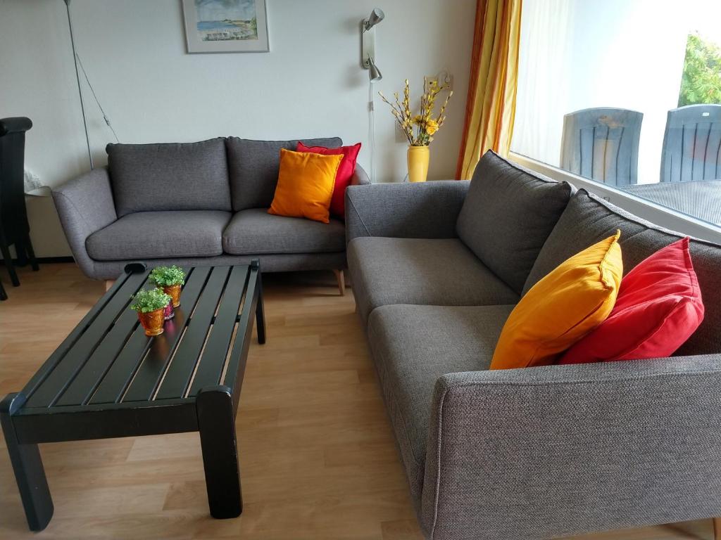 a living room with two couches and a coffee table at DUINZICHT 6 Bed by the Sea in Westkapelle