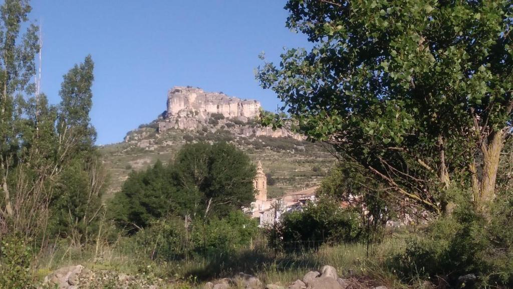 a castle on top of a mountain with trees at La Caseta in Forcall