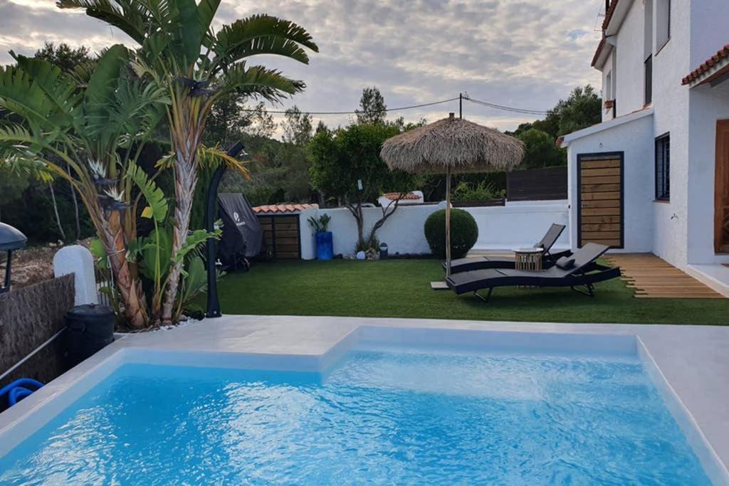 a swimming pool in the backyard of a house at MAS BLANC in Calafell
