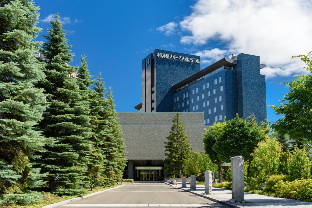 a building with a parking lot in front of it at Sapporo Park Hotel in Sapporo