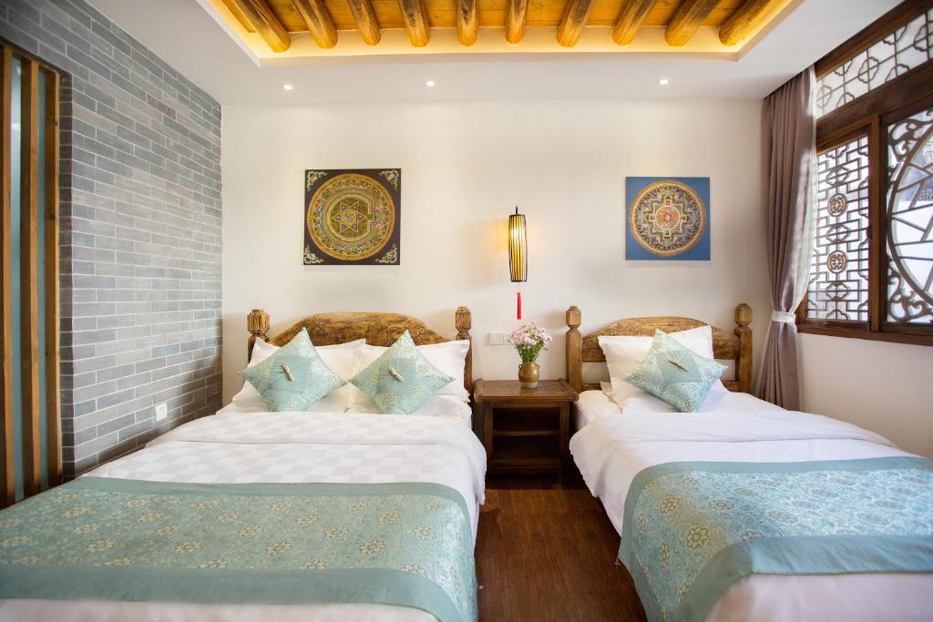 Postel nebo postele na pokoji v ubytování 夕露小榭古城南门店 Xilu Xiaoxie Inn Old Town Lijiang