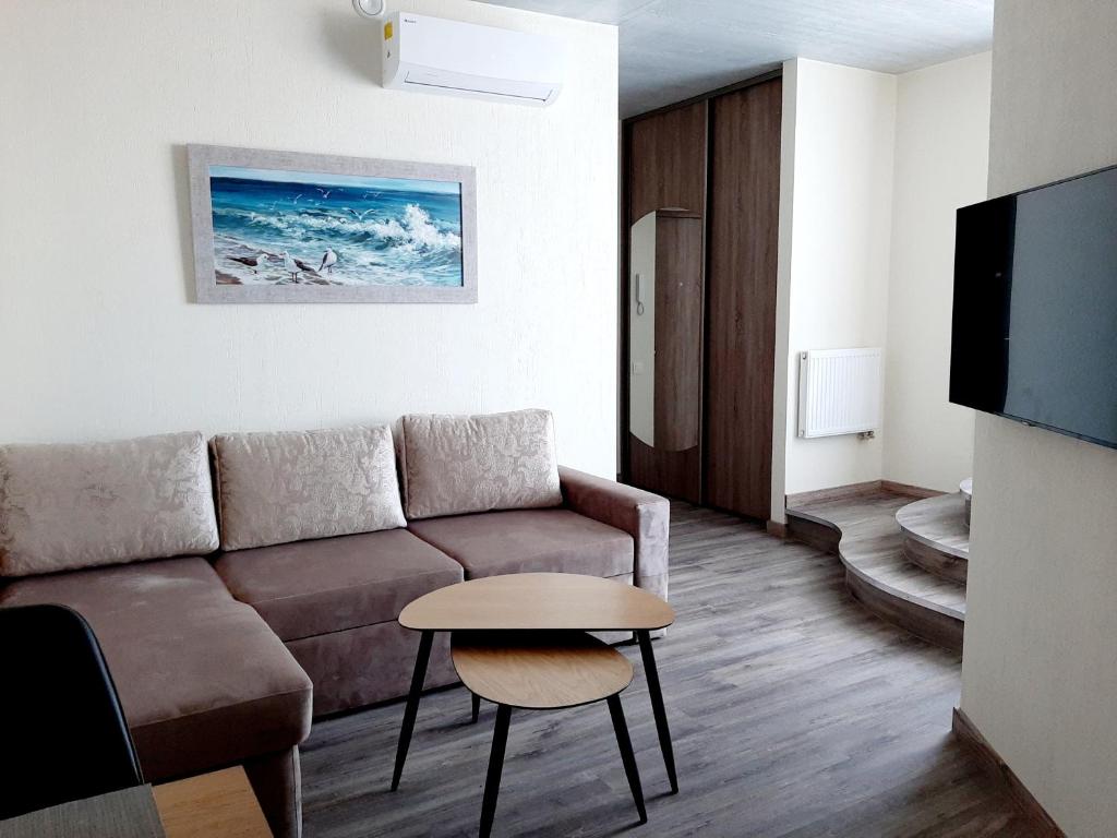 uma sala de estar com um sofá e uma mesa em Smeltale apartament 3 em Klaipėda