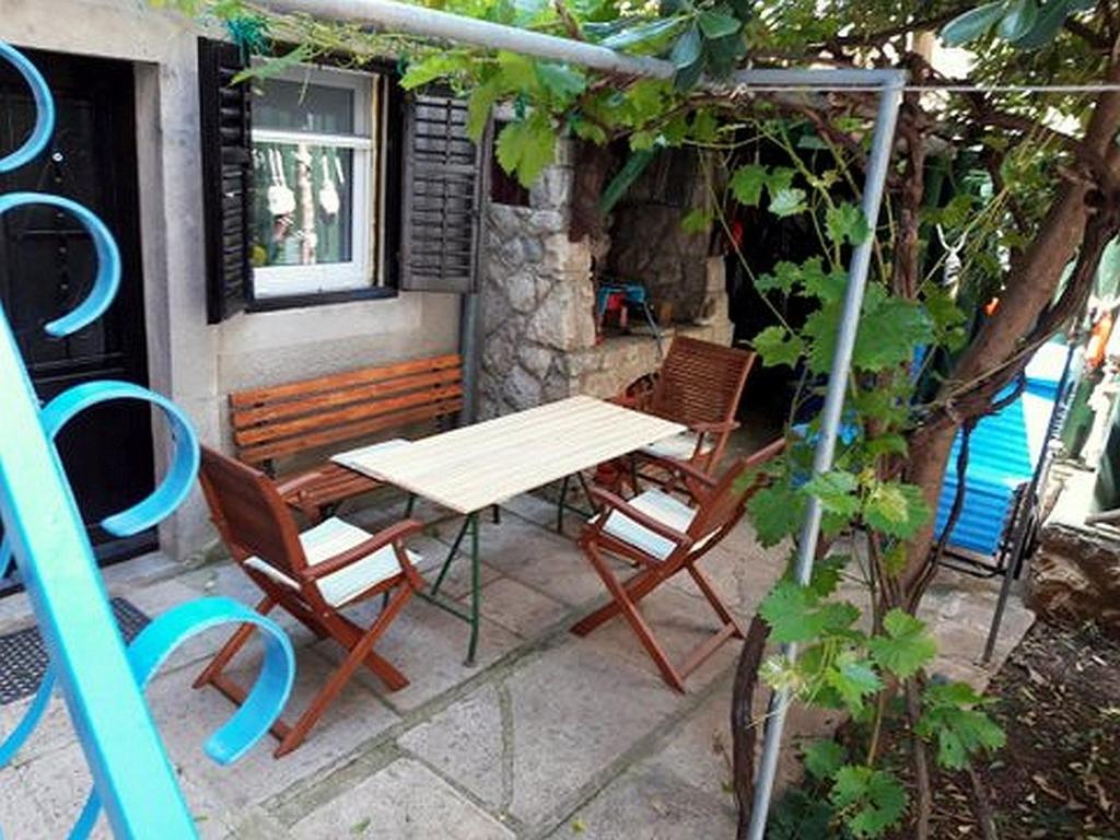 a wooden table and chairs sitting on a patio at House Markovina in Cres
