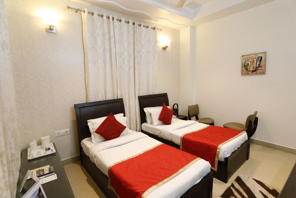 Postel nebo postele na pokoji v ubytování Hotel Yog Vashishth