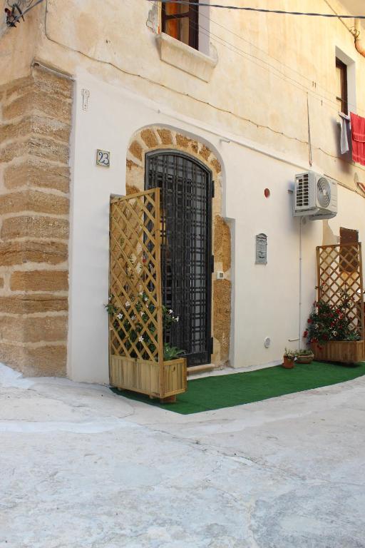 a door to a building with a green floor at Alle Grottine in Sciacca