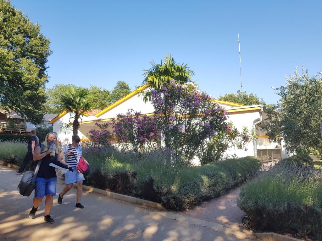 a group of people walking down a street at Mobile Homes Banko in Bijela Uvala and Zelena laguna in Poreč