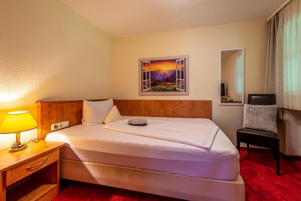 Postel nebo postele na pokoji v ubytování Hotel Neudeck