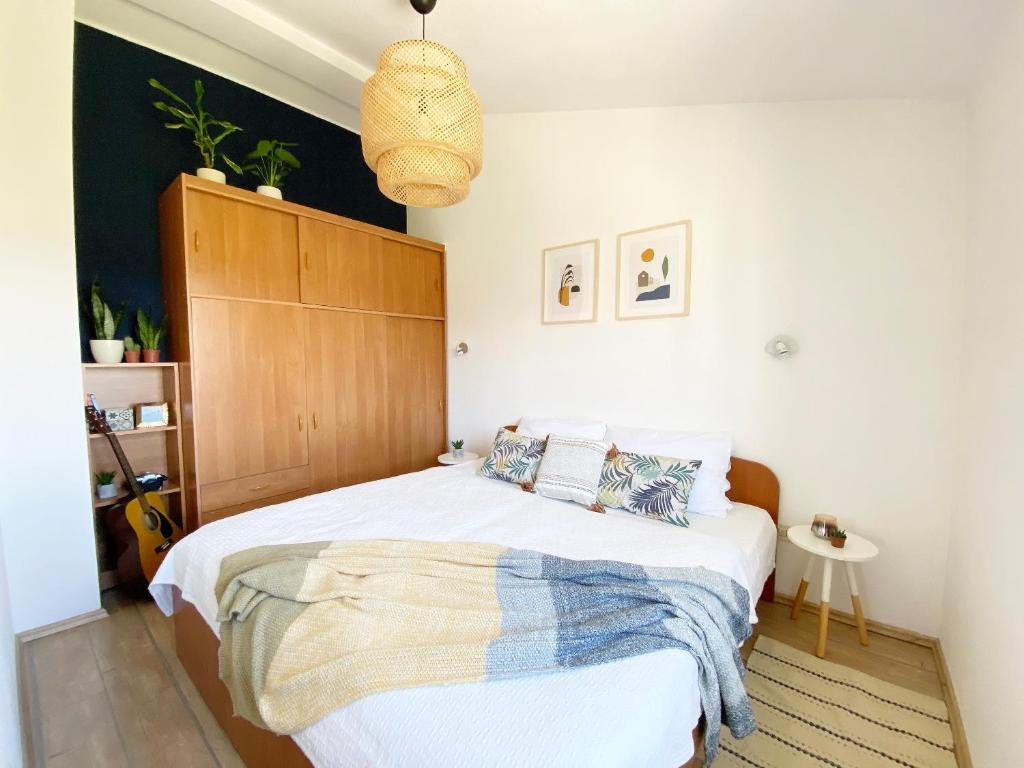 a bedroom with a bed with a wooden headboard at Apartments Mester in Sveti Anton