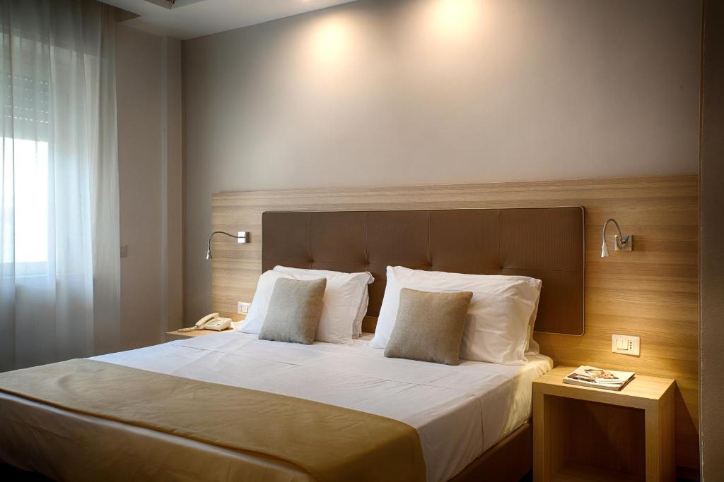 Łóżko lub łóżka w pokoju w obiekcie American Hotel