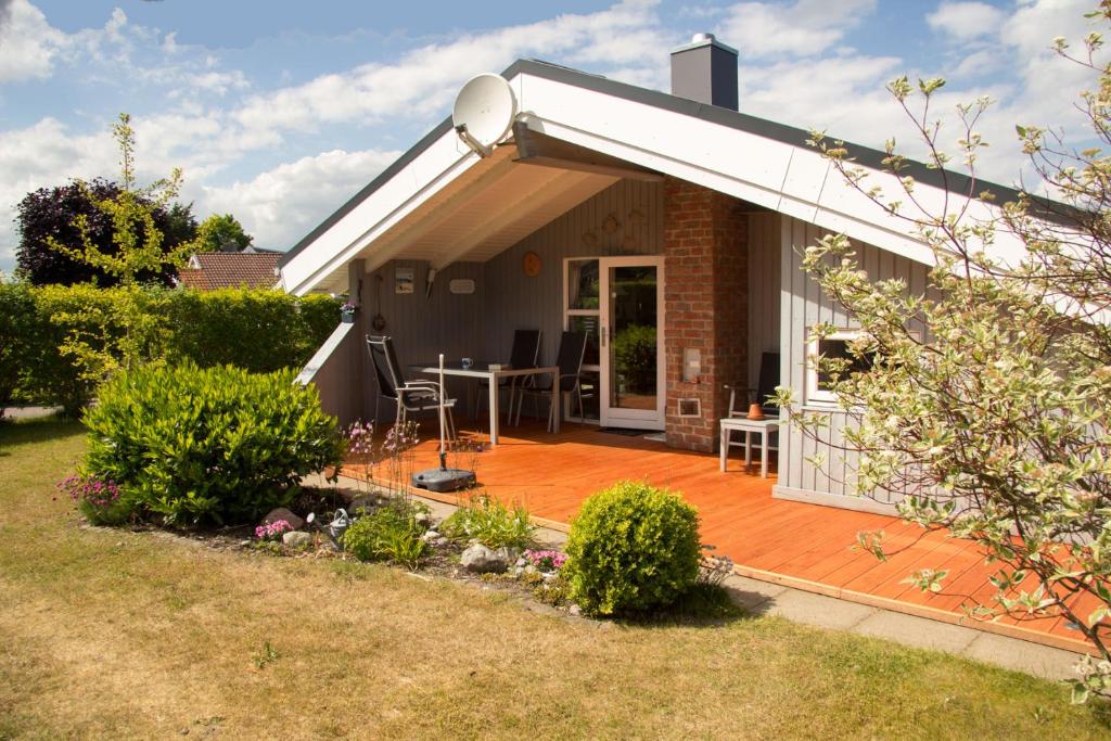 a house with a deck and a patio at Ferienhaus Solvej Schönhagen in Brodersby OT Schönhagen