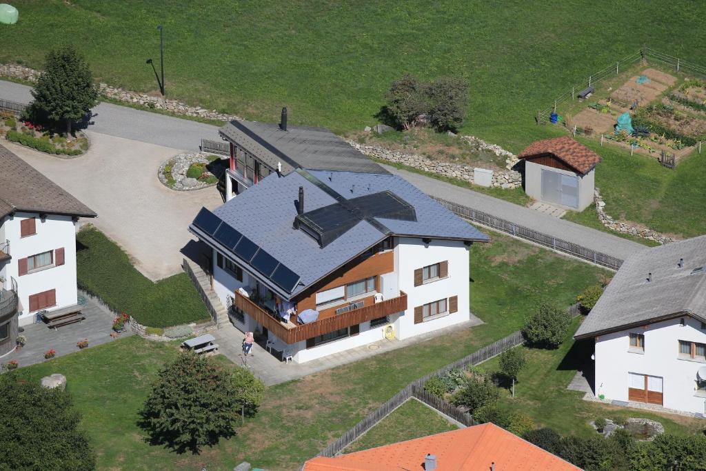 an overhead view of a house with a blue roof at Casa Sper Gassa in Disentis