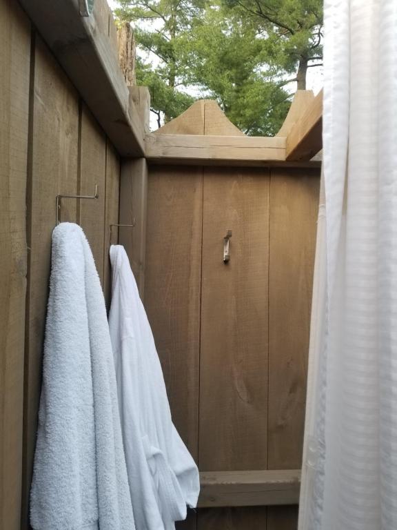 a bathroom with white towels hanging on a wall at Four Ninety Muskoka B & B in Gravenhurst
