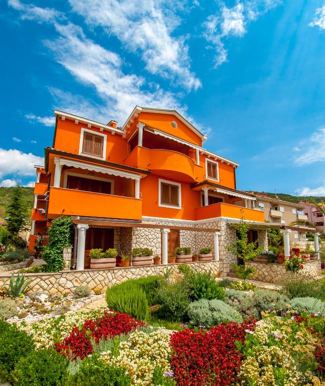 a house with a garden in front of it at Villa Magnolija in Cres