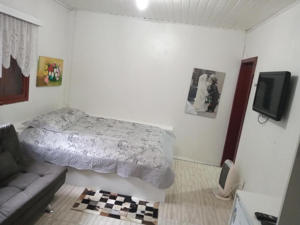 Un pat sau paturi într-o cameră la Hospedagem dona Tania
