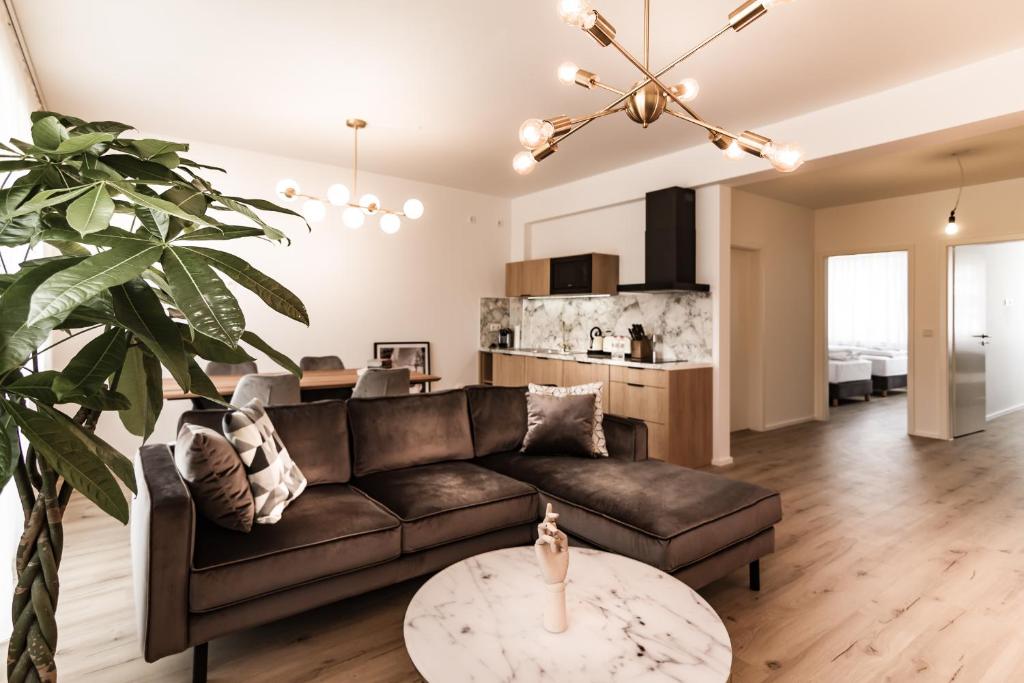 a living room with a couch and a table at Sleep Inn Wehrhahn Suites in Düsseldorf