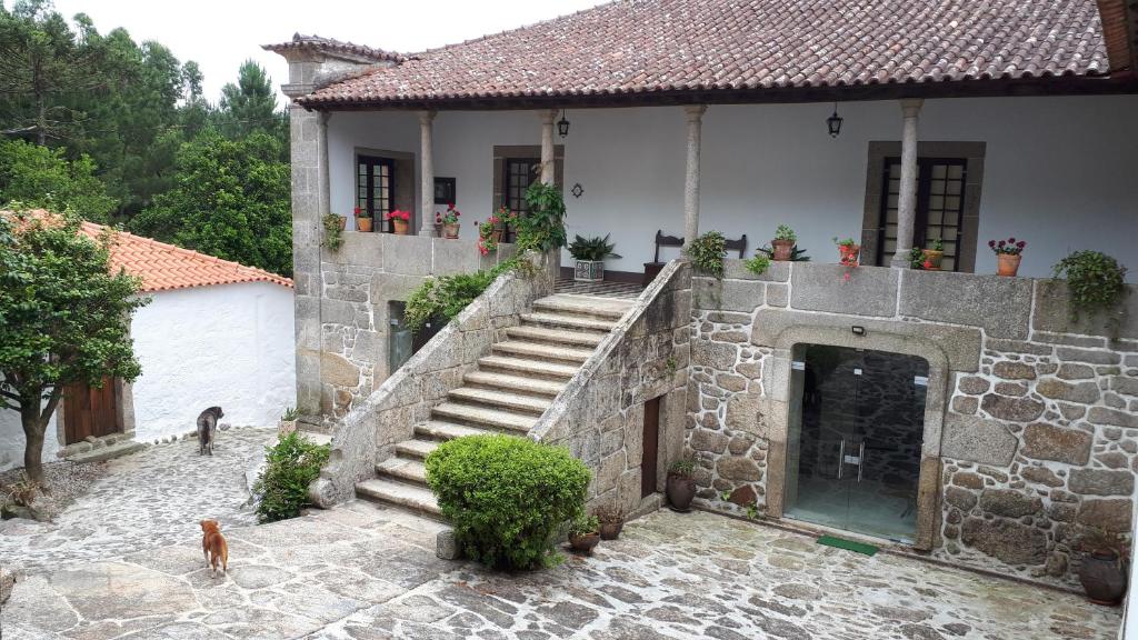 a stone house with a staircase and a door at Quinta do Bravio in Barroselas