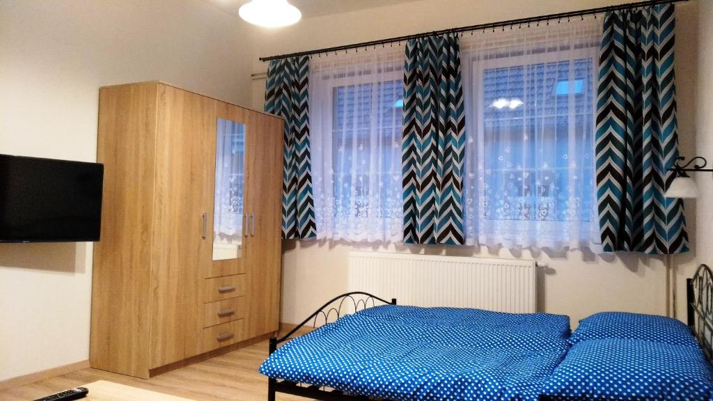 Postel nebo postele na pokoji v ubytování Apartmány Kukaččí hnízdo