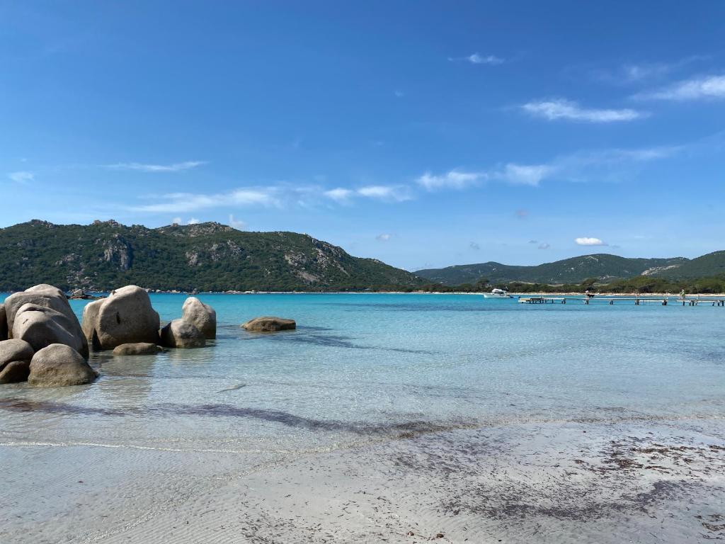 a beach with some rocks in the water at Appartement 2 pièces dans le centre historique de Porto Vecchio in Porto-Vecchio